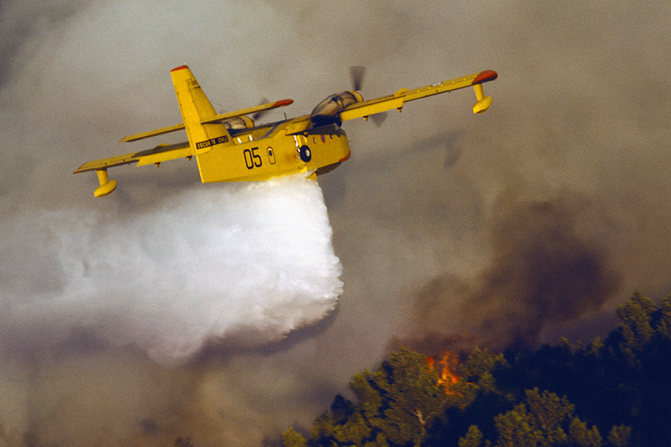 A Canadair CL-215—the world’s only purpose-built airtanker—swoops low over a wildfire in Provence, France. (STOCKFOLIO® / Alamy)