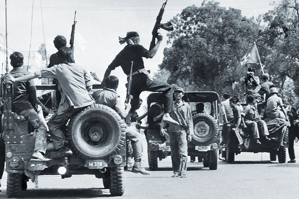 Khmer Rouge insurgents drive through Phnom Penh on April 17, 1975, celebrating their capture of Cambodia’s capital. (Sjoberg/AFP/Getty Images)