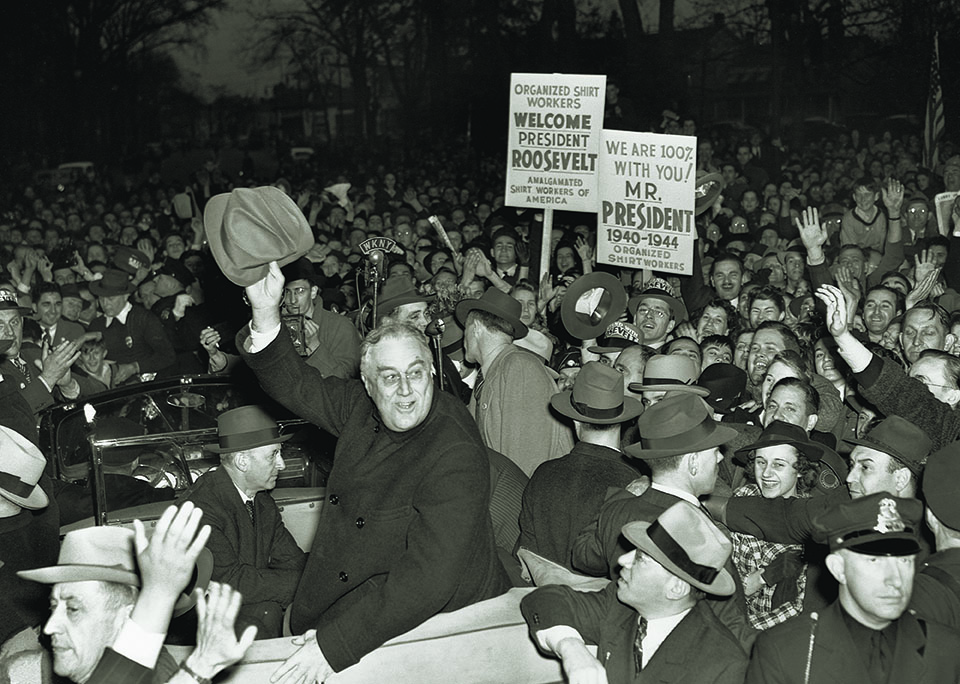 A consummate politician, FDR promised during the campaign “not to send American boys into any foreign wars.” At top, the president heads toward Hyde Park —and victory—on election day. (Bettman/Getty Images)