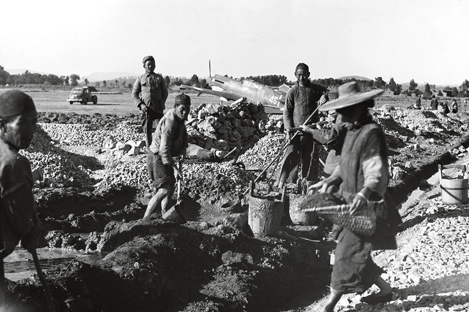 Kunming airfield, shown here under construction by Chinese laborers, saw frequent use by the Fourteenth’s aircraft. (Hulton-Deutsch Collection/Corbis)