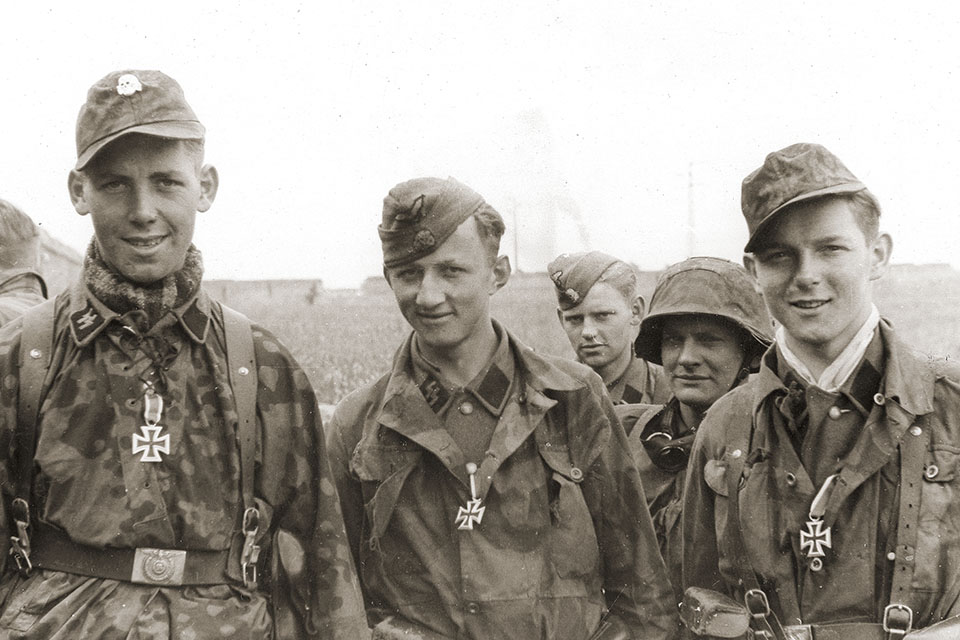 Young members of Hitlerjugend wear newly awarded Iron Crosses earned during the Battle for Caen. (Ullstein Bild/Getty Images)