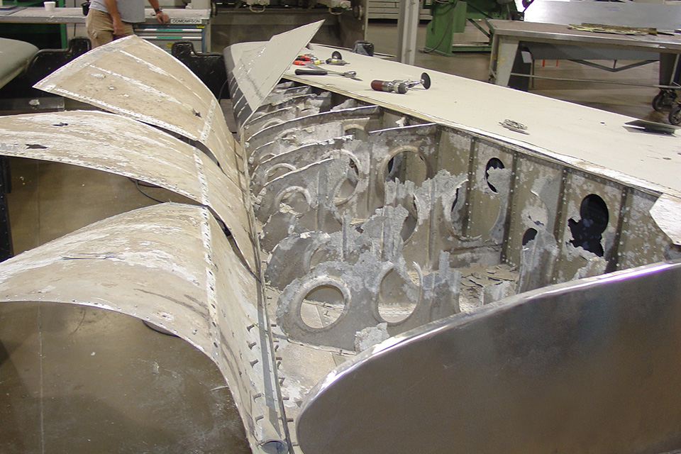 Folding back the aluminum skin revealed significant corrosion inside the tail section. (55th Maintenance Section)