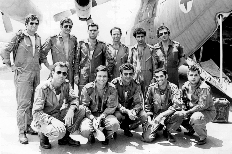 The crew of the first C-130 that landed at Entebbe poses with their plane after the mission. Joshua Shani is at center in the front row. (Israel Air Force)