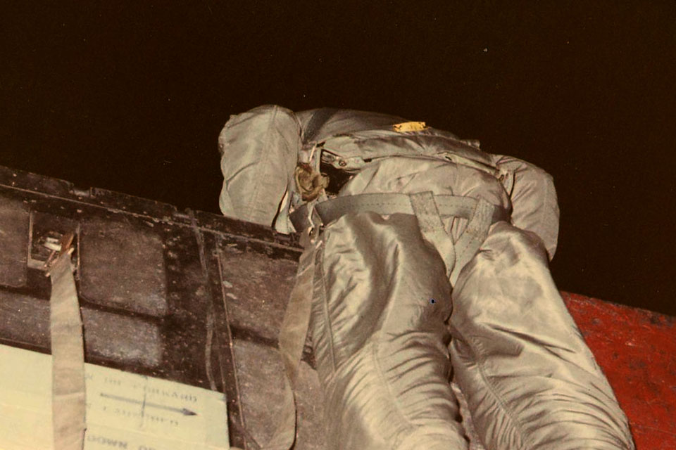 Low tech lookout. As Bob Savage did for pilot Ed Holley on March 2, 1971, a crewman hangs over the ramp of a Spectre, scanning the ground below to alert the pilot in the event of a missile launch. (Spectre Association)