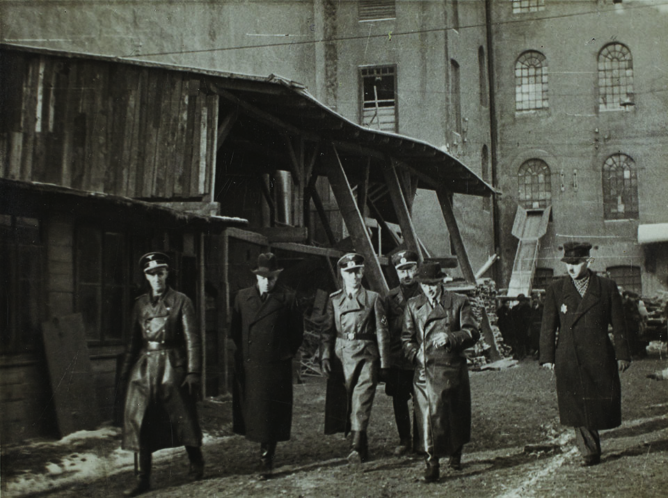 SS SHAKEDOWN: Members of the Gestapo (opposite, top) arrive to inspect Lodz’s factories. Jewish hard labor helped manufacture war supplies —including leather, textiles, and timber—that the Germans exploited to fill their coffers. Many Jewish workers endured abuse and torture at the hands of their oppressors. 