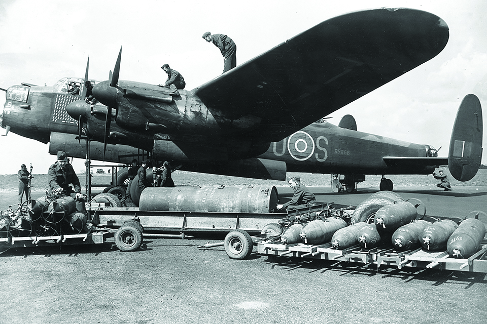 Ground crewmen prepare to load ordnance into a Lancaster prior to a mission. (Getty Images)
