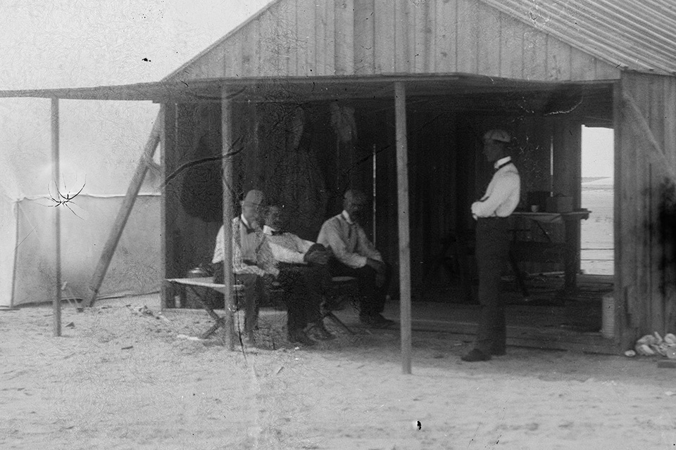 From left, Octave Chanute, Orville Wright, and Edward Huffaker are joined by Wilbur Wright in the Wrights’ shed at Kitty Hawk, N.C. Chanute was a friend and mentor to the Wrights. (Library of Congress).