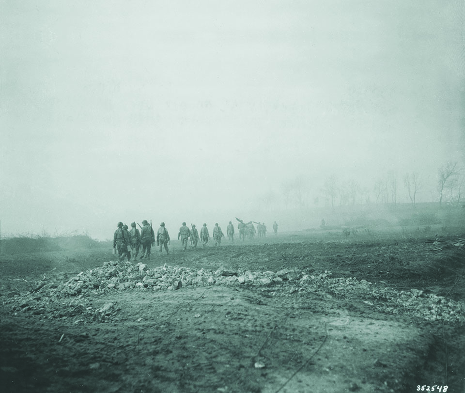 During a two-hour truce, the Germans allowed litter bearers and soldiers of the 36th (here a few days earlier) to collect their dead and wounded. (National Archives)