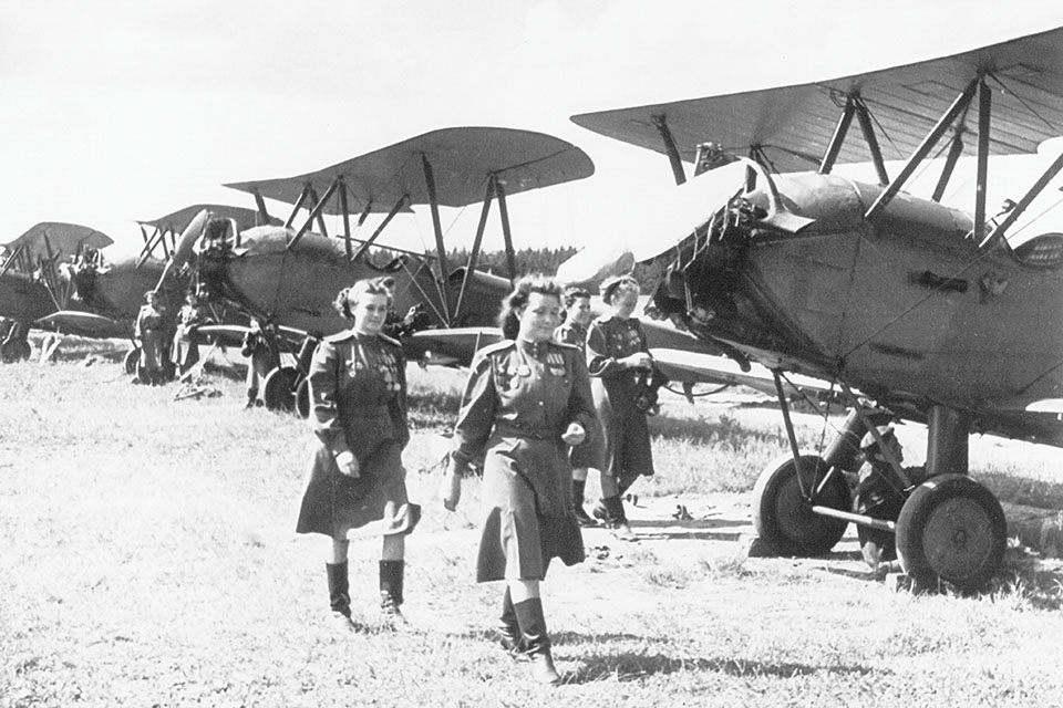 Pilots of the 588th Night Bomber Regiment, aka the “Night Witches,” walk in front of a line of Po-2s at a Soviet air force base in 1944. (akg-images)