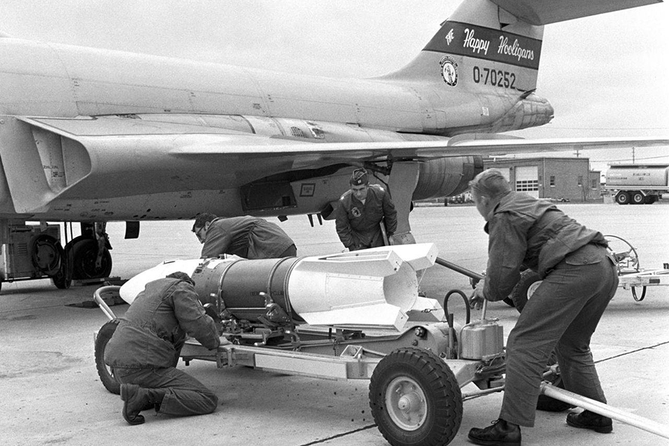 A load crew moves an AIR-2A missile into position for loading on an F-101B from the North Dakota Air National Guard. (U.S. Air Force)
