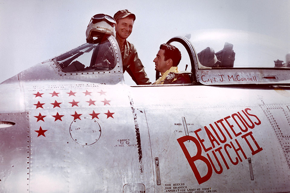 On May 18, 1953, “Mac” McConnell talks with a member of his ground crew for the cockpit of his F-86F after his final combat mission. (U.S. Air Force)