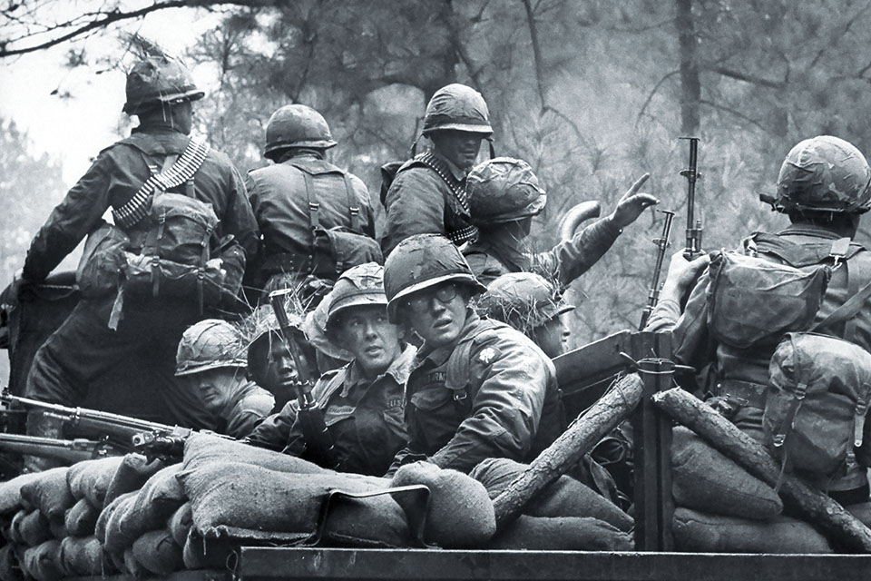 Infantry trainees at Fort Polk, Louisiana, in 1966 wait for a mock ambush. More soldiers were shipped to Vietnam from Fort Polk than from any other American training base. (Lynn Pelham/The Life Picture Collection/Getty Images)