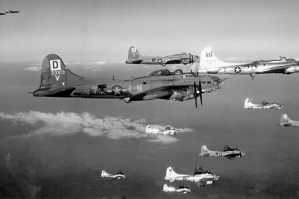 A mixed squadron of 100th Group Flying Fortresses includes a veteran B-17F (foreground) among the newer camouflaged and bare-metal B-17Gs. (National Archives)