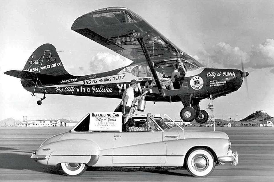 The Aeronca Sedan "City of Yuma" takes on supplies from a Buick in 1949. (AP Photo/Yuma Daily Sun)