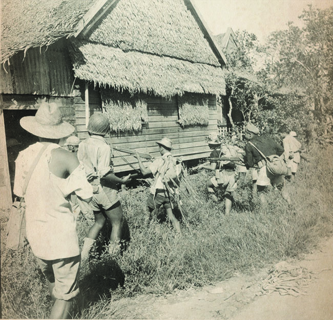Filipino guerrillas scour houses in Leyte for signs of the enemy. On Luzon, 200 such volunteers joined a guerrilla force led by Walt Cushing. (National Archives)