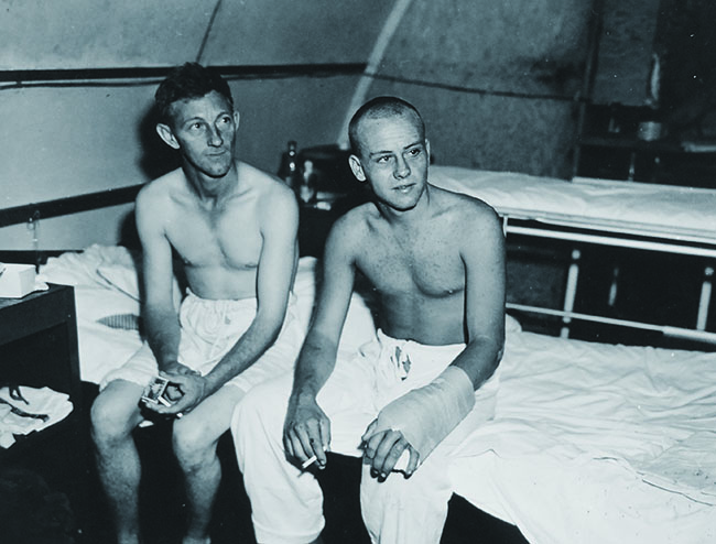 Survivors of the sinking included Willie Hatfield and Cozell Smith, whose left arm was bandaged from a shark bite. (U.S. Navy/ National Archives)