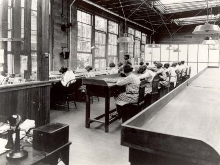 Young women painting gadgets with radium-activated paint in a factory, circa 1922.