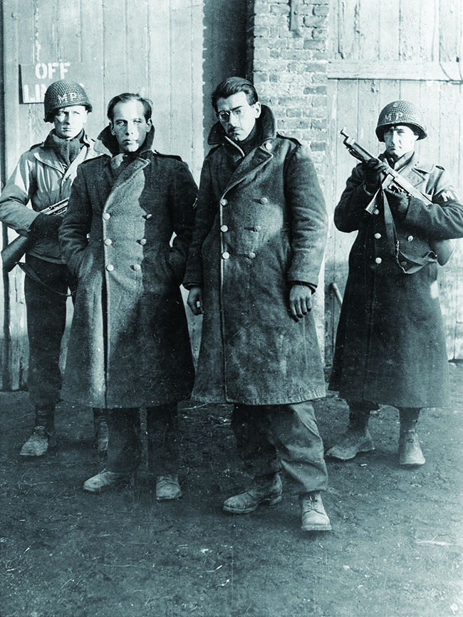American MPs guard two of Skorzeny’s commandos, captured wearing American garb. Both men were swiftly tried and executed. (Photo by Alamy)