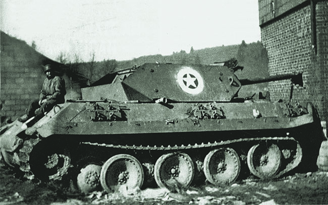 A GI rests upon Skorzeny’s sole surviving Panther—disguised to resemble an American M10 tank destroyer. Turret reversed, it had backed into the German command post during the fighting. (HistoryNet Archives)