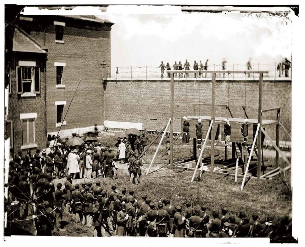 Was Holt Merciless?: At far left, Mary Surratt dangles at the end of a rope on July 7, 1865, the day she was hanged with other Lincoln assassination conspirators. Circumstantial evidence suggests that Holt may have intentionally failed to notify President Andrew Johnson about the court’s recommendation for mercy for Surratt. (Library of Congress)