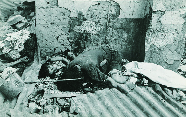 A mother and child are among the victims of widespread butchery. Civilian dead totaled around 100,000—many tortured and murdered. (National Archives)