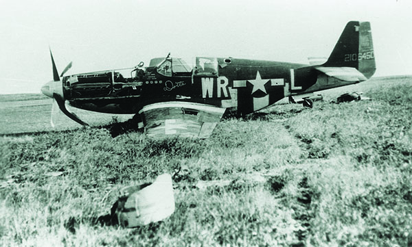 Having crashed on takeoff, a P-51 lies crippled near the Steeple Morden runway. Gray’s Mustang went down in much more dangerous territory, northwest of Berlin. (Roger Freeman Collection, FRE 2935)