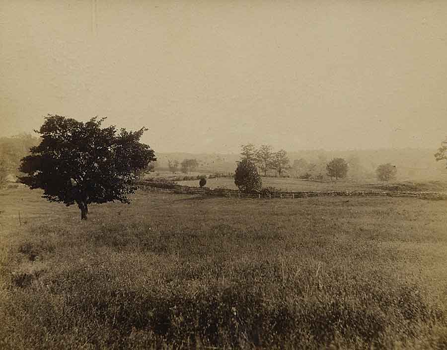 #49 | Sept. 21, 1891 | 8 a.m. The “Ten-acre corn field” or the “little corn field” Smoketown road in “the lane” Sam Poffenberger’s plowed field “Camera in nearly same position as in Nos. 36-39 & 49. From the knoll of the 128th Penn. regiment. Looking east: to the rear. The mulberry tree so prominent here has probably grown since the war. The stonewall and post and rail fences here seen have replaced the “worm fences” of 1862. This view, and Nos. 35 & 36 taken together, give a good idea of the route of advance of the 10th Maine. The 10th Maine crossed the Smoketown road (as well as I can now tell) about where the small bush is growing, to right of the mulberry tree. We came to ‘Front’ when east of the road, then advanced down and up the gentle slope, and deployed about in the shadow of the tree on the extreme right of the picture.” (Courtesy of John Banks)