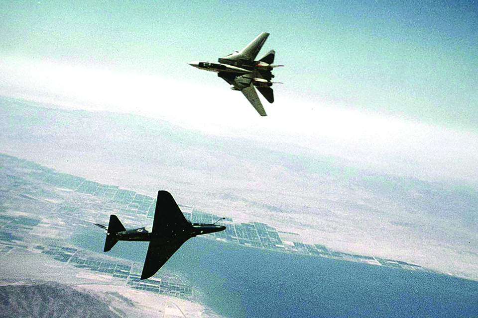 An F-14A and A-4F make a close pass during a Topgun dogfight in 1982. (U.S. Navy)