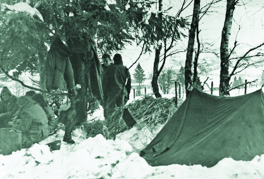 Troopers hunker down at a B Company command post. Conditions at the Bulge were miserable—especially for the underequipped 551st. STAFF SERGEANT CHARLES S. FAIRLAMB, 551ST PIB, VIA LESTER HUGHES.