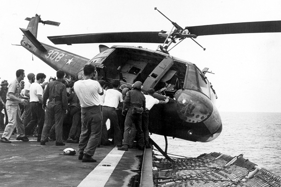 When it became clear that deck space was at a premium with the influx of helicopters headed to the Midway, Capt. Lawrence Chambers ordered some of the helicopters pushed overboard to make room. (Rolls Press/Popperfoto via Getty Images)