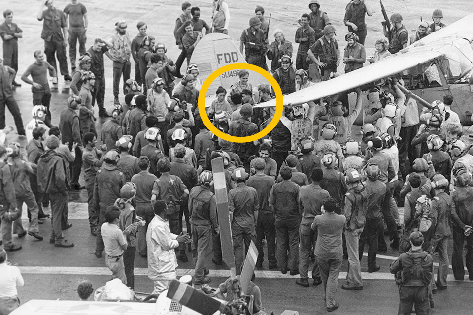 Sailors rushed to the deck to hold down Buangâ€™s plane. His wife, youngest child, circled, climed out. The other children followed. (USS Midway Museum)