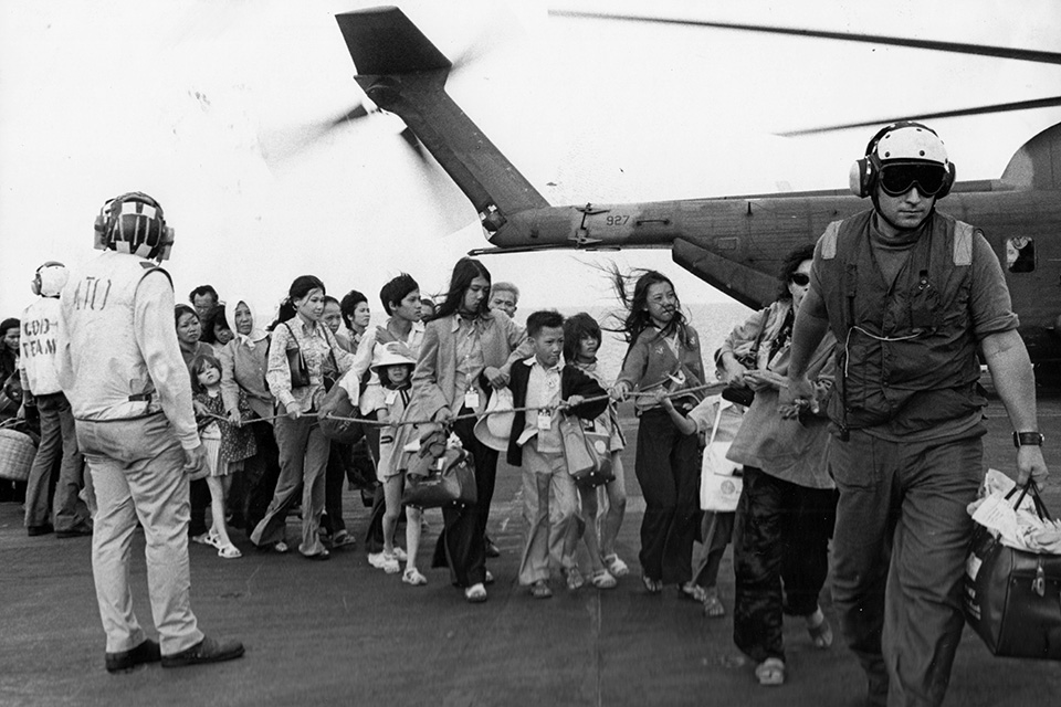Refugees on the Midway are led by the crew to a place where they can get medical care. (USS Midway Museum)
