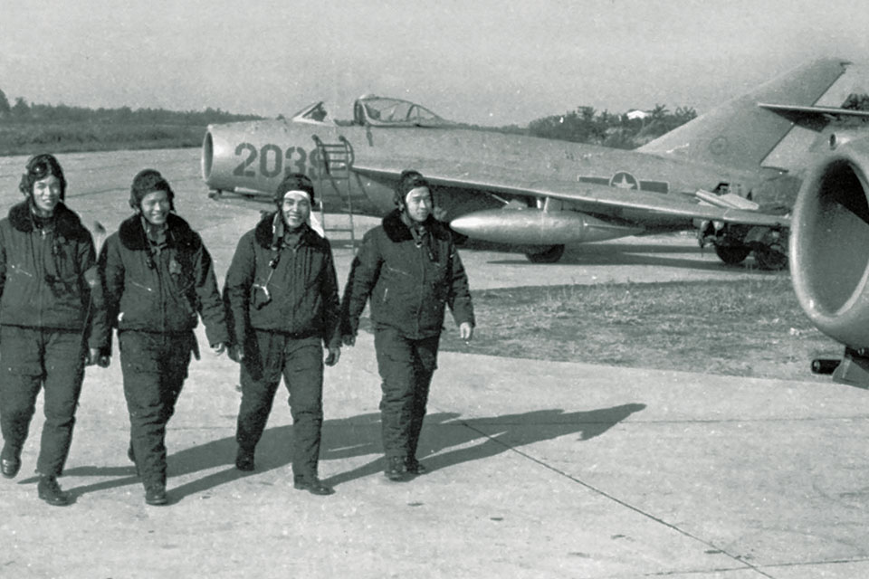 Four North Vietnamese pilots from the 923rd Fighter Regiment in June 1967, walk in front of their MiG-17s, aircraft that suffered heavy losses in combat. (Vietnamese News Agency)