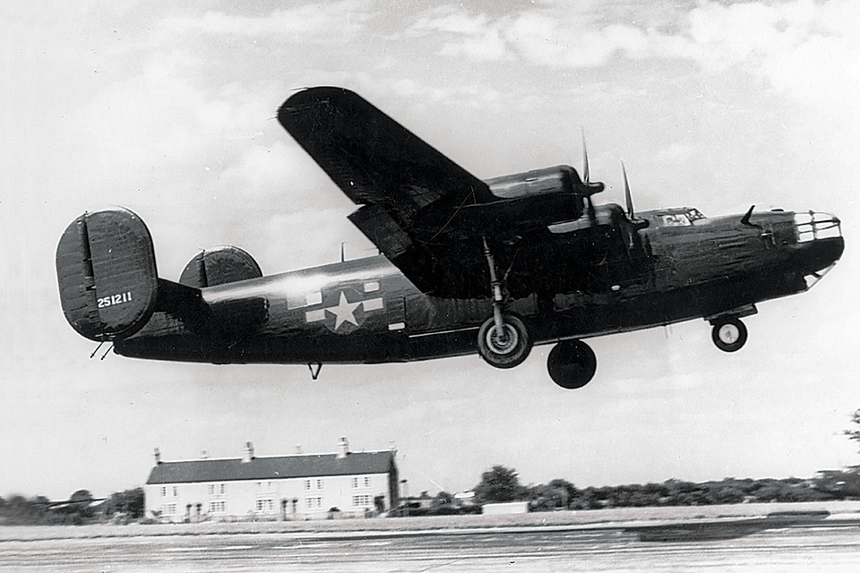 “Miss Fitts,” a Carpetbagger B-24D with an extended nose greenhouse for night observation, takes off from RAF Harrington. (National Archives)