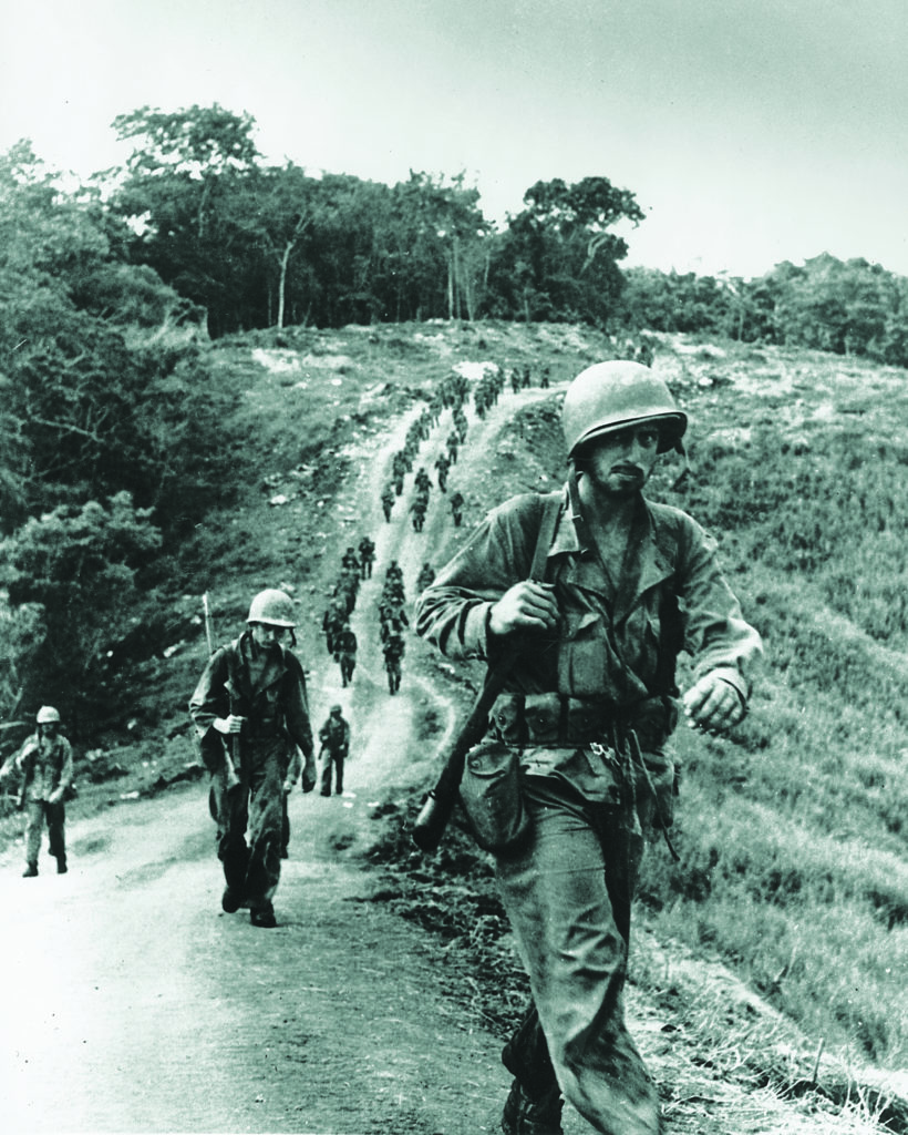 U.S. soldiers trek across the high hills of Guadalcanal. (AP Photo)