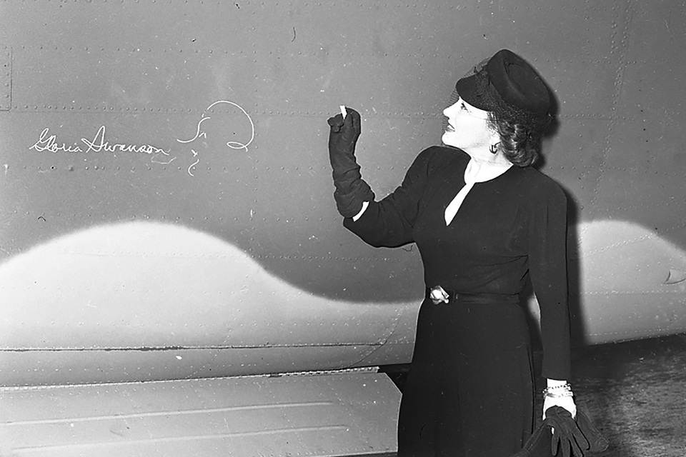 Movie star Gloria Swanson signs B-24H no. 42-52117 as it leaves the Willow Run bomber factory, one of the many Liberators built at the facility near Detroit, Mich. (Yankee Air Museum)