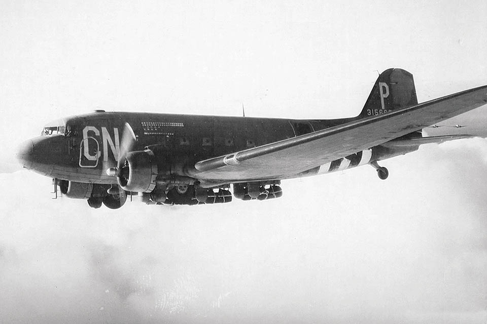C-47A 43-15665 of the 434th Troop Carrier Group, en route to Normandy with parapacks under its wings, later became the first airplane to land on the North Pole, on May 3, 1952. (National Archives)