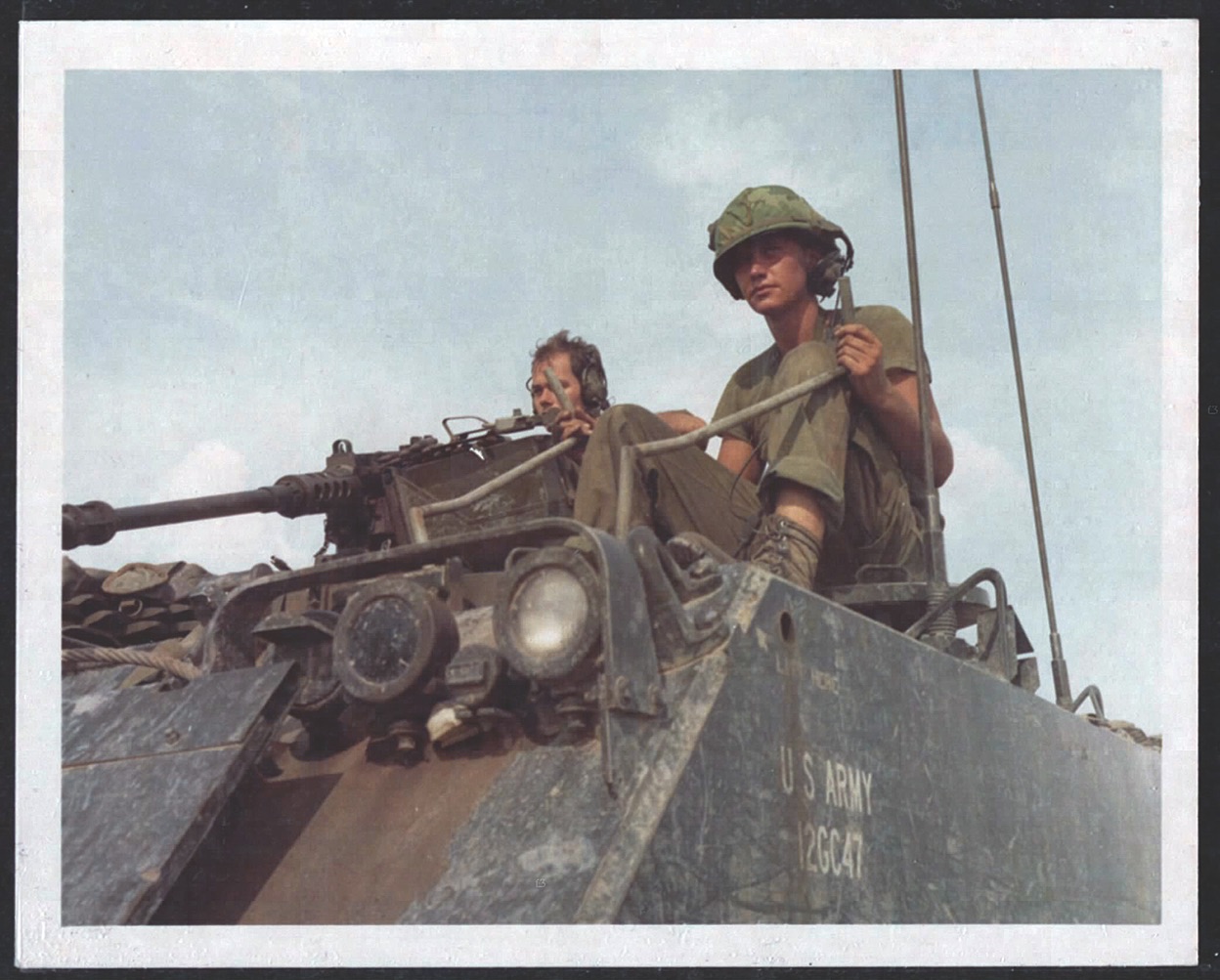 The driver and gunner on an M113 in the 4th Battalion, 23rd Infantry, move through Ho Bo Woods in October 1967. (U.S. Army/National Archives)
