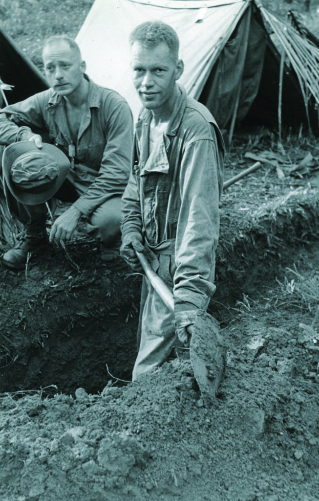 A weary Cook digs his second foxhole of the day on Rendova Island (above). The artist’s fatigue was soon replaced by terror, as later captured in a haunting air raid self-portrait (header).