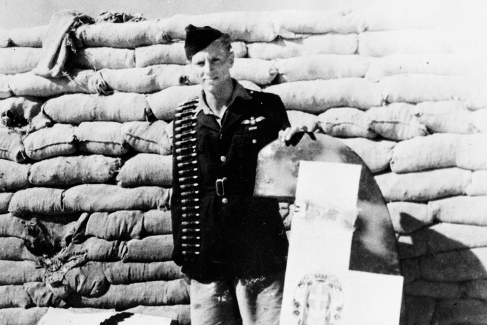 Beurling shows off souvenirs from one of his Malta victories. (IWM CM 3658)