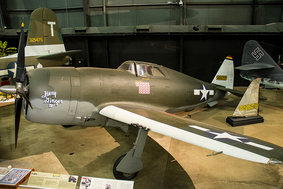 The recovered vertical stabilizer of "Fiery Ginger IV" is displayed next to a P-47D bearing its full livery at the Air Force museum. (National Museum of the U.S. Air Force)