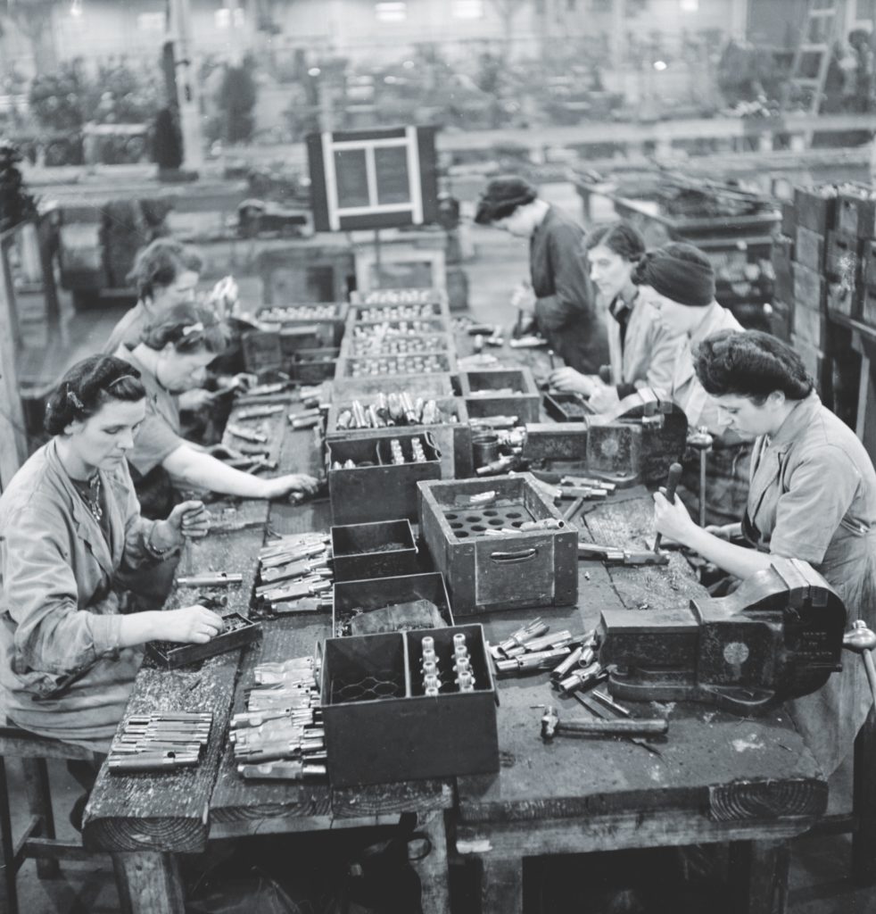 Workers at ROF (Royal Ordnance Factory) Fazakerley in Liverpool, England, assemble breech blocks for the Sten. (Imperial War Museums) 