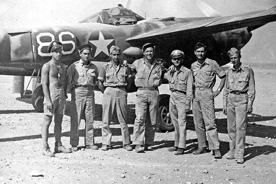 Pilots of the 37th Fighter Squadron pose with a P-38 at Gambut, Libya, the day after their October 9 mission. From left are Thomas Smith, Homer Sprinkle, Harry Hanna, Wayne Blue, Leverette, Robert Margison and Elmer La Rue. (Leverette family)