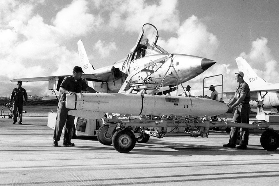 The Thud was originally designed to carry a nuclear weapon, in this case a dummy practice bomb being loaded into an F-105B in 1961. (U.S. Air Force)