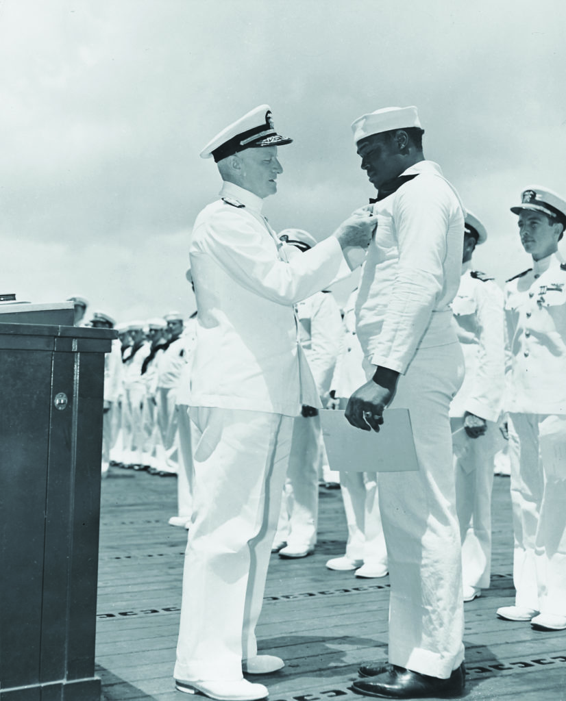 Admiral Chester W. Nimitz awards Miller the Navy Cross; a Pittsburgh paper campaigned for him and started the "Double V" campaign, for victory both abroad and for black Americans at home. (Naval History and Heritage Command)