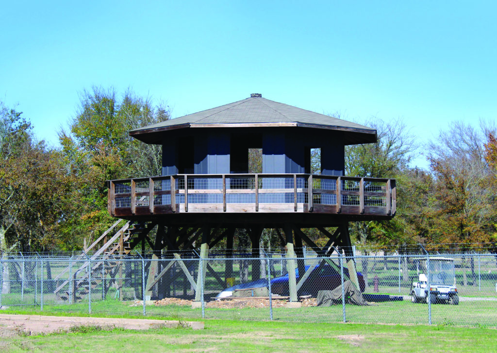A rebuilt period barracks at Camp Hearne contains the main museum exhibit and a reconstructed guard tower. (Gerald E. McLeod)