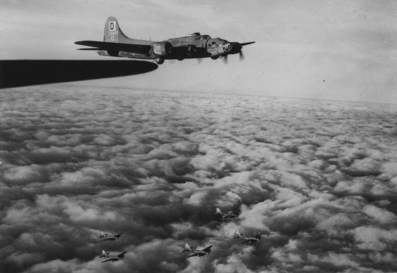 "Alice from Dallas" of the 100th Bomb Group flies in formation above the clouds. (Roger Freeman Collection, American Air Museum in Britain)