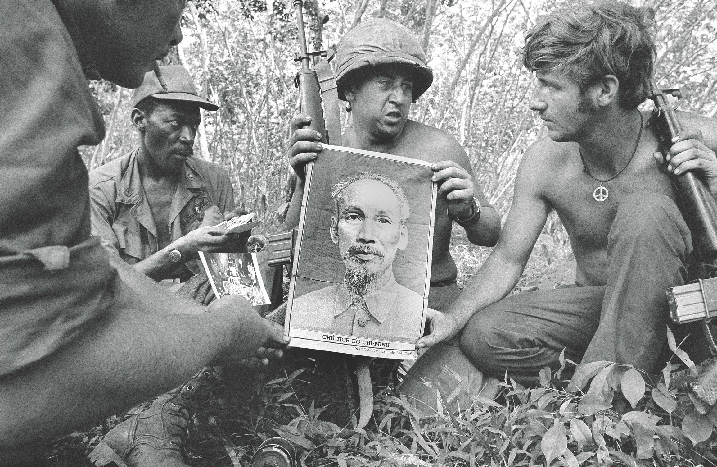 American GIs show a cloth portrait found during the search of a rubber plantation in Cambodia in 1970. (AP Photo/Henri Huet)