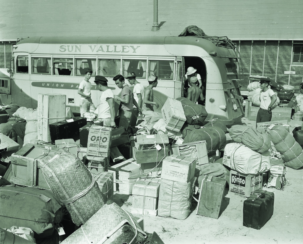 Minidoka internees sort luggage trucked in from a temporary holding camp at Puyallup, Washington. (National Archives)