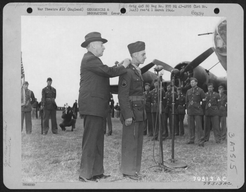 Secretary of War Henry L. Stimson hangs the Medal of Honor on Smith’s neck (above) in a July 15, 1943, ceremony; a flyover of 18 B-17s (below) followed. (U.S. Air Force/National Archives)